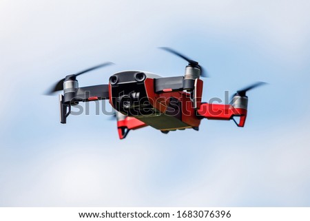 Small red quadrocopter in the air