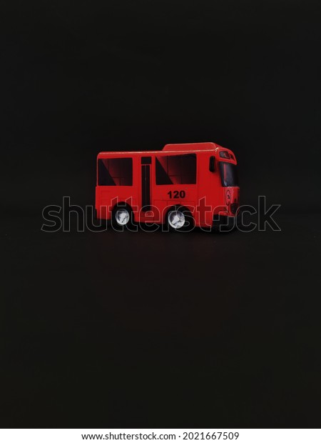 small red toy car on\
black background