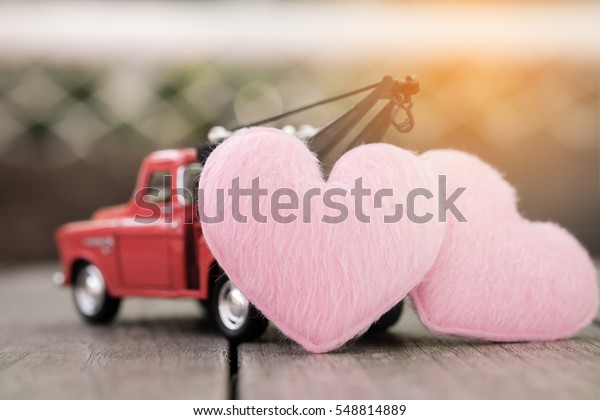 Small red toy car and pink hearts for valentine\'s\
Day, Vintage Tone