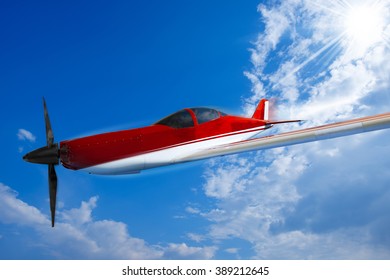 Small Red And White Private Airplane Propeller In Flight With Blue Sky And Clouds