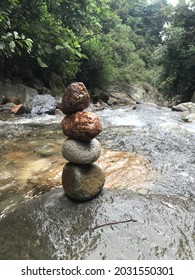 Small River Stones Piled Up In A Clear River