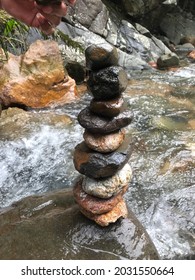 Small River Stones Piled Up In A Clear River