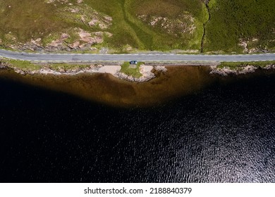 Small Road By A Lake. Top Down Aerial View. Transportation Industry. West Of Ireland. Connemara. One Car Pared Of Road. Fishing Area.