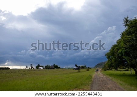 small road with moody cloud sin country side 