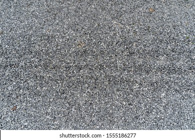 Small rocks or gravel used for construction of buildings, roads and for landscaping. Granular abstract uniform grainy surface. Break stone background. Road gravel. Gravel texture.