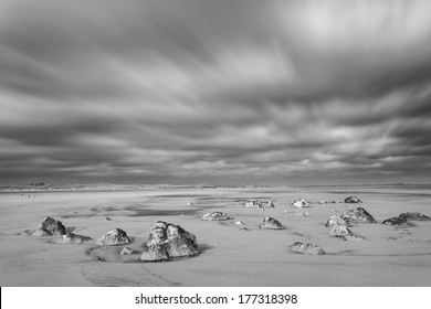 Small Rocks on the Beach with a Dramatic Sky. Processed in Monochrome 