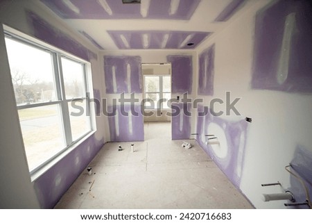Small room under construction, featuring a prominent large window