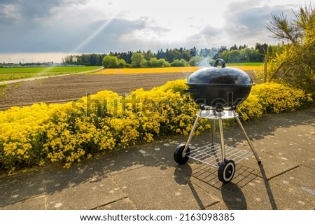 Small round charcoal grill in nature. Charcoal on the grill
