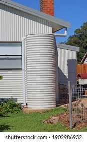 Small Round Metal Water Tank On The Side Of A House