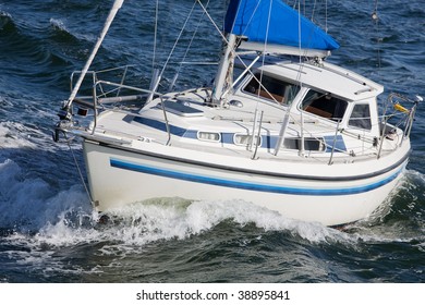 Small Sailboat Cuts Through The Waves On The Baltic Sea