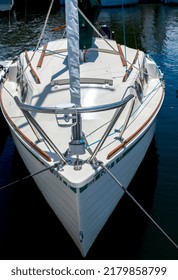 Small Sailboat With Wooden Trim And An Outboard Motor.