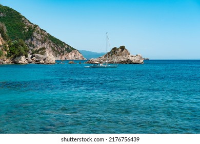 Small Sailing Boat At Anchorage At Beautiful Natural Bay 