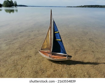 The Small Sailing Boat On The Big Lake