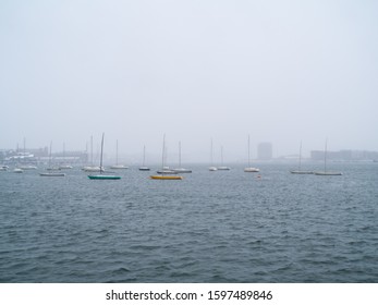 Small Sailing Ships Anchored In Boston Harbor On A Snowy Day