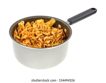 A Small Saucepan With Cooked Pasta In Tomato Sauce With Vegetables On A White Background.