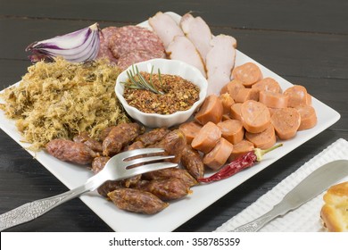 Small sausages, hot dogs, przenica, ham on a plate