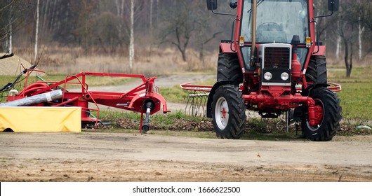 Small scale farming with tractor and plow in field.
