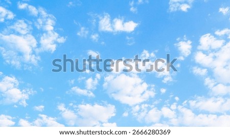 Small and scattered white clouds in a clear blue sky. Sky and cloud landscape. Fresh air sky background photo.
