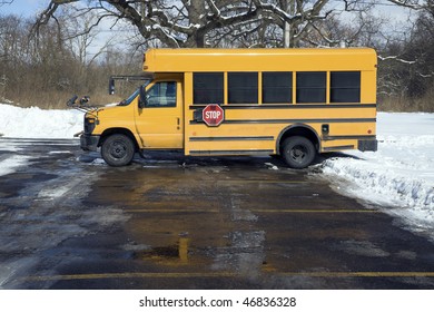 Small School Bus On The Parking Lot - Winter Time.