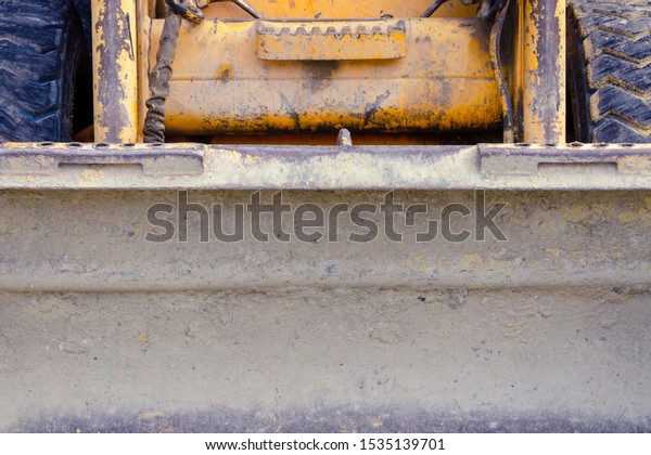 small scratched\
bulldozer. construction equipment. fruitful work concept. small\
tractor after work. work\
concept