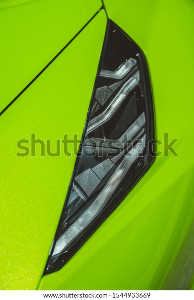 Small and\
sharp details of lime green sport car.\
