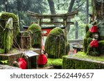 Small shinto place of worship with Torii Gates and inscriptioned stones at  Fushimi Inari Taisha temple in Kyoto, Japan. ( Japanese inscriptions translated are different religion blessings)