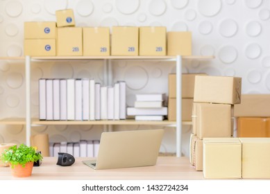 Small shipping  Or home office With a laptop and a barcode scanner on the product's desk Including brown boxes on the table and shelves For product delivery to customers Order online, e-commerce   