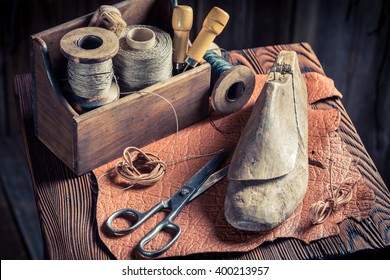 Small Shoemaker Workplace With Tools, Leather And Shoes