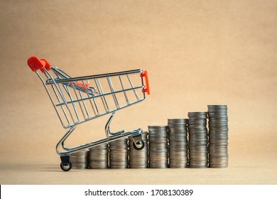 Small Shopping Cart Going Upward On The Heap Coins Stairs, Increase Sales, Upgrade Retail Business Concept