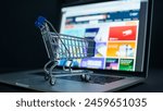 Small shopping cart on a laptop keyboard signifies convenience in digital purchases