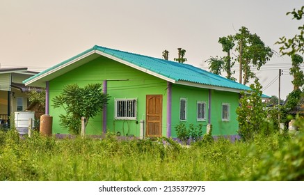 A Small Simple House In A Grass Background.       