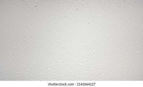 Small size water drops wet glass surface on grey background, Misted glass | Overlay foreground or background for shower hygiene and skin moisturizing beauty products - Shutterstock ID 2142664127