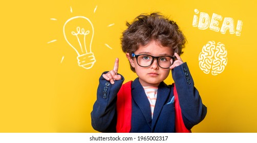 Small smart child in glasses with bag isolated on yellow. Little genius student thinking with lightbulb and math formulas. Student has idea. Pupil with picture of brain. Kindergarten kid go to school. - Shutterstock ID 1965002317