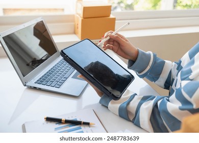 Small SME entrepreneurs who operate businesses using their homes as offices and sell products through online applications are checking product stocks to ensure they are sufficient to meet orders. - Powered by Shutterstock