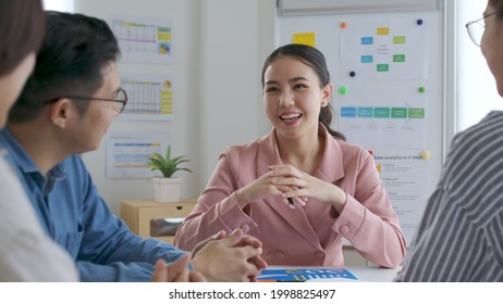 Small sme group asia young female leader people sale staff sit smile work share data plan idea on desk table in happy workplace workforce skill team from mentor coach training mba class at office.