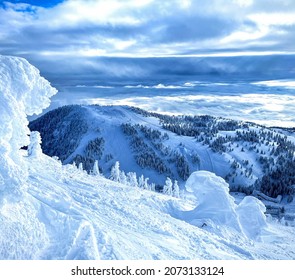 Small snowdrifts are scattered around the picturesque wintry backcountry overlooking the Vogel ski resort slopes. Spectacular shot of gorgeous winter wonderland in the Slovenian part of Julian Alps.
