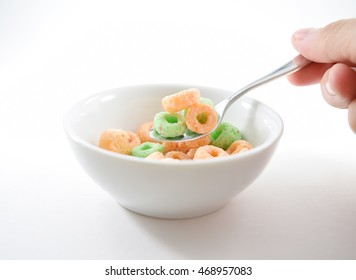 Small Spoon Scooping Colored O-shaped Sugary Cereal