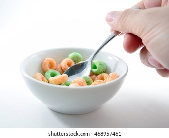 Small Spoon Scooping Colored O-shaped Sugary Cereal