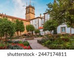 Small square in Santiago de Compostela city with flower garden and fountain, Galicia, Spain. Popular touristic landmark