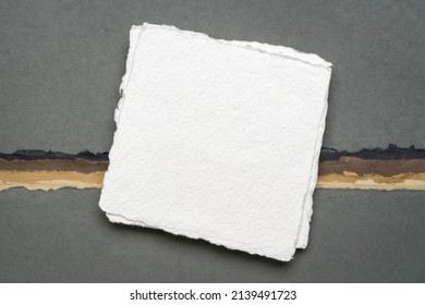 small square sheet of blank white Khadi paper against abstract paper landscape in earth colors