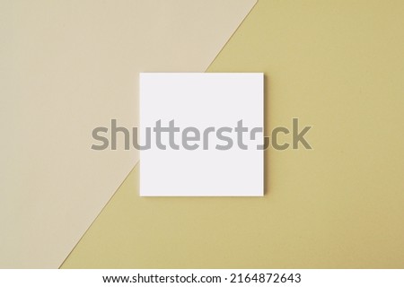 Small square sticky notes or notepad mockup on beige light brown background, for design presentation or message.	
