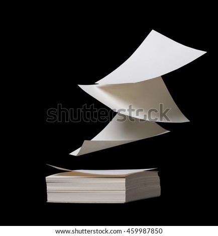 Small square white papers are freely floating on a stack 