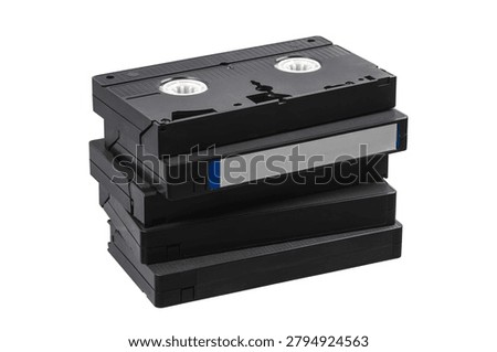 A small stack of black retro VHS videotapes isolated on a clean white background.