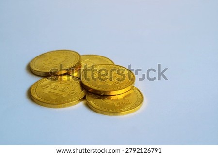 ​A small stack of physical golden Bitcoin coins isolated on white background. Cryptocurrency market, blockchain technology investment, and digital finance asset concept.