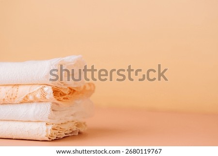 Small stack of white and peach lace, side view. High quality photo