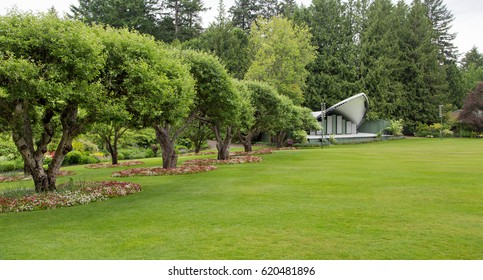 A Small Stage On A Large Green Lawn In A Public Garden