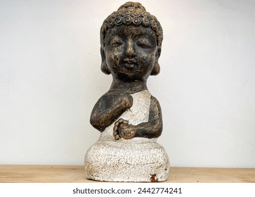 Small statue decorations for table and interior, little buddha statue modern simplistic house environment with several pottery and wooden table
