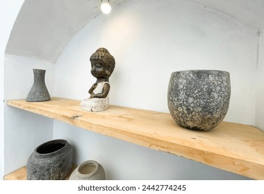 Small statue decorations for table and interior, little buddha statue modern simplistic house environment with several pottery and wooden table
