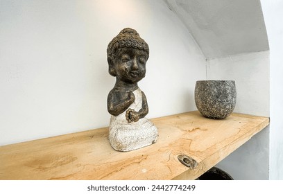 Small statue decorations for table and interior, little buddha statue modern simplistic house environment with several pottery and wooden table