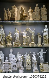 Small Statues Of The Greek Gods On The Shelfs In The Greek Souvenir Shop.